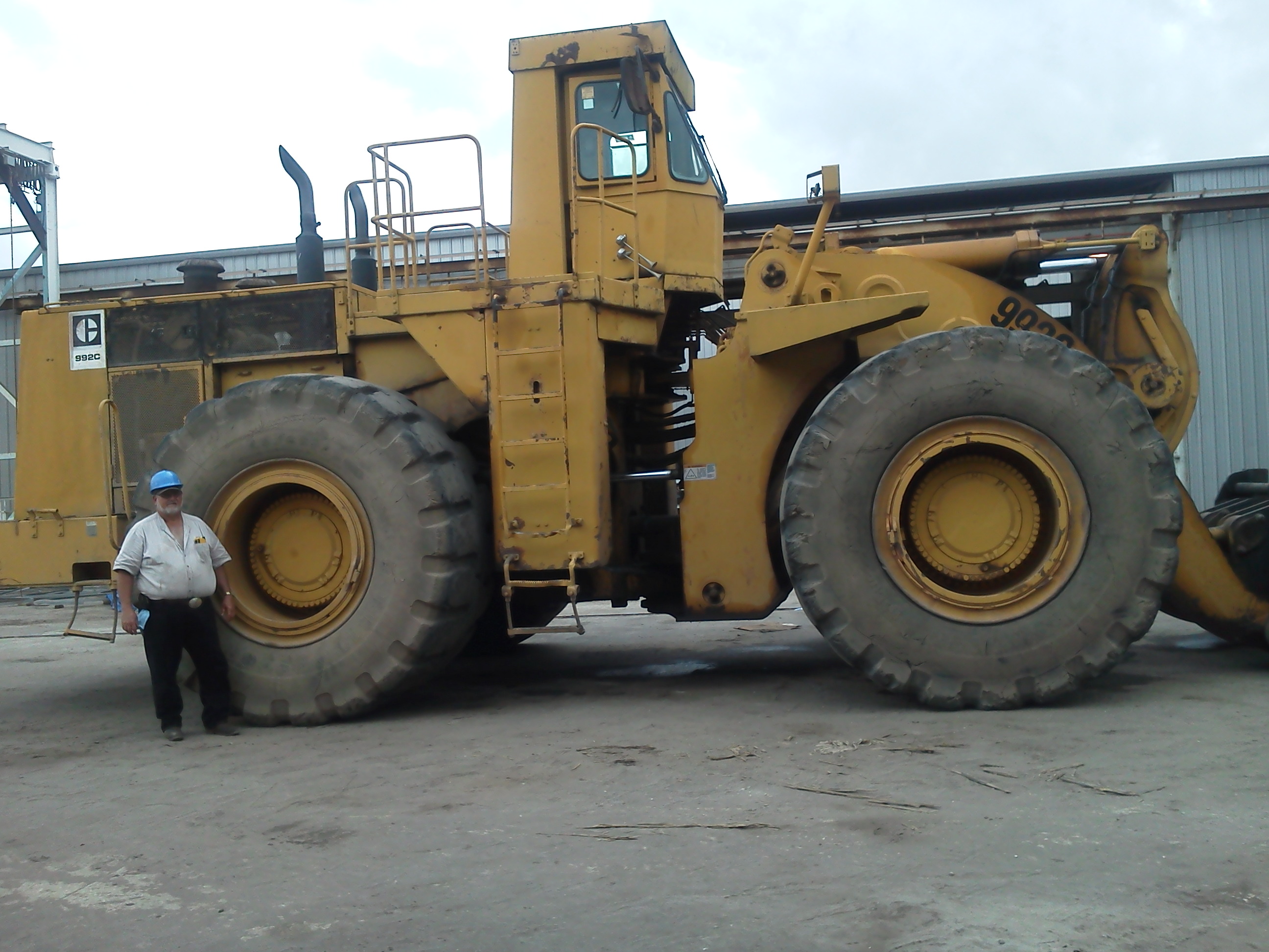 Owner of R&R Equipment Repairs standing next to a CAT front-end loader at the Lecanto, FL shop